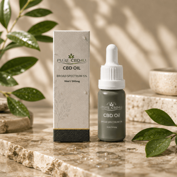 Luxury lifestyle image of Pure CBD4U Broad Spectrum CBD Oil 5% 500mg 10ml bottle with premium packaging on a natural stone surface with water droplets and botanical elements.